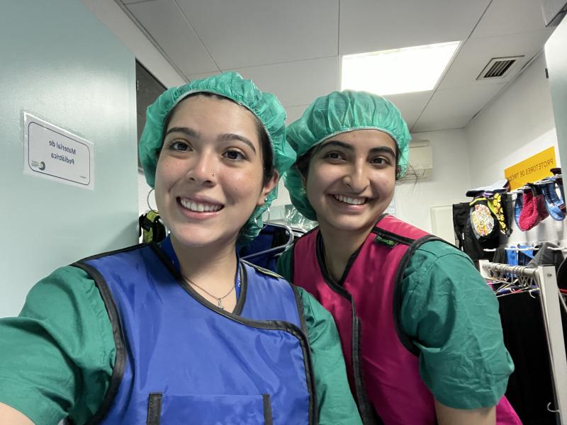 Two girls in scrubs smiling for a picture